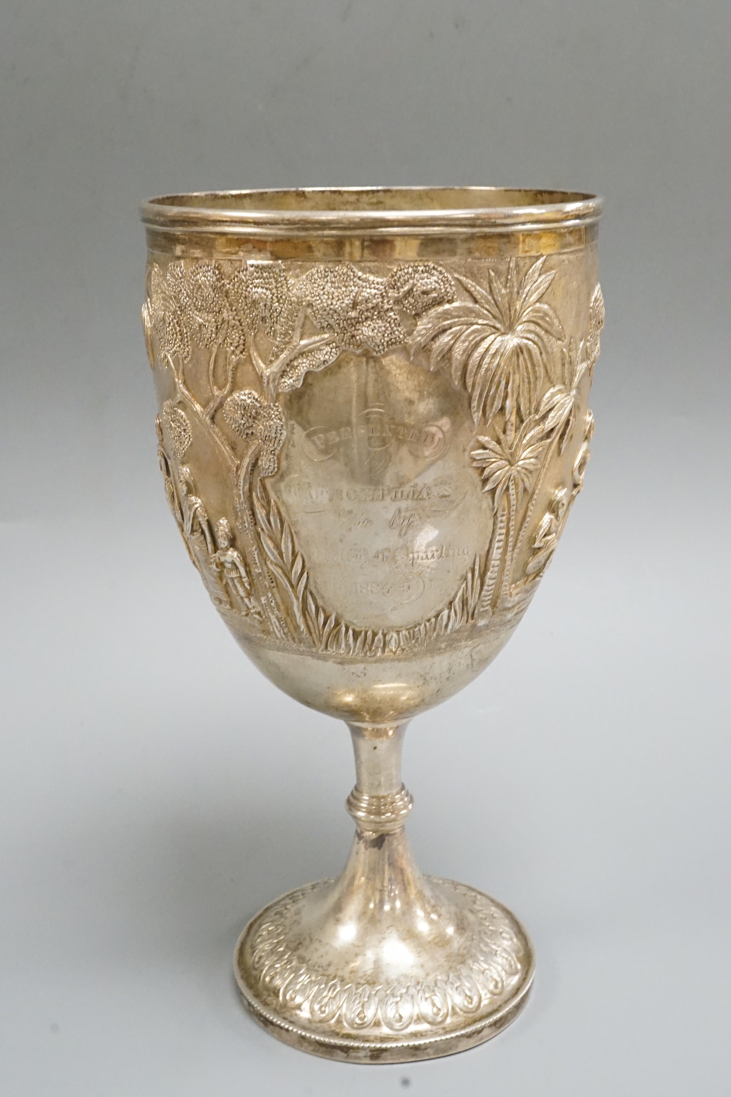 A 19th century Indian embossed white metal presentation goblet, with engraved inscription, 22.7cm, 14.7oz.